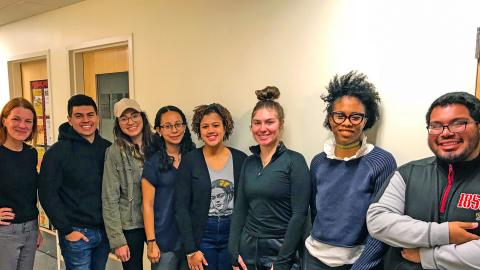 Eight students pose together for a picture.